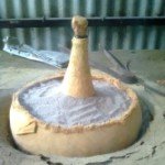 Himveda Medicine inside bottle immersed in sand